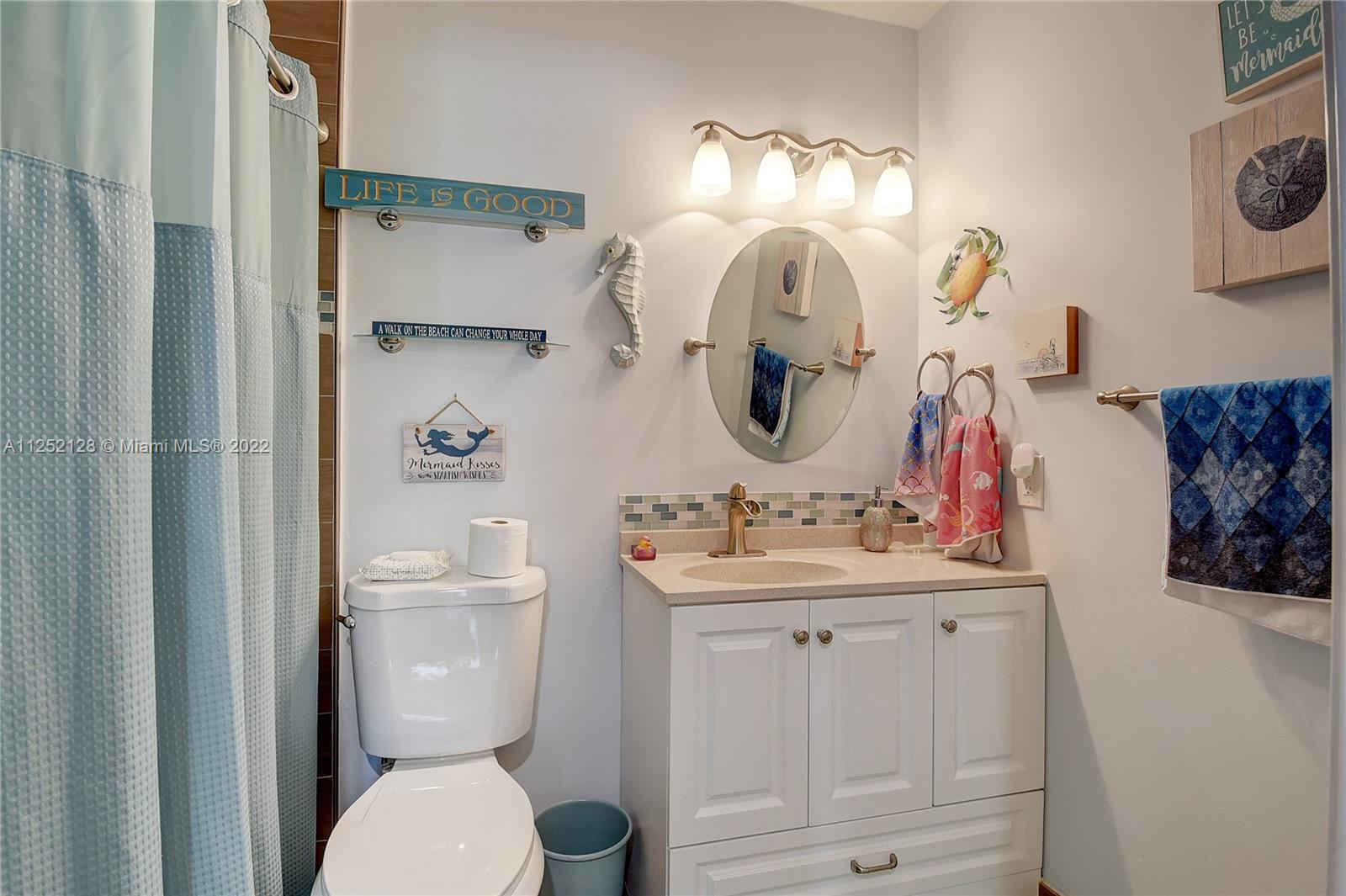 Boca Gardens Boca Raton, FL 33496 - Photo 11 of 19 a bathroom with a toilet sink and mirror
