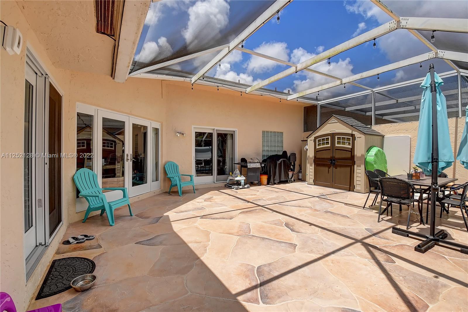 Boca Gardens Boca Raton, FL 33496 - Photo 12 of 19 a view of a porch with furniture and floor to ceiling window