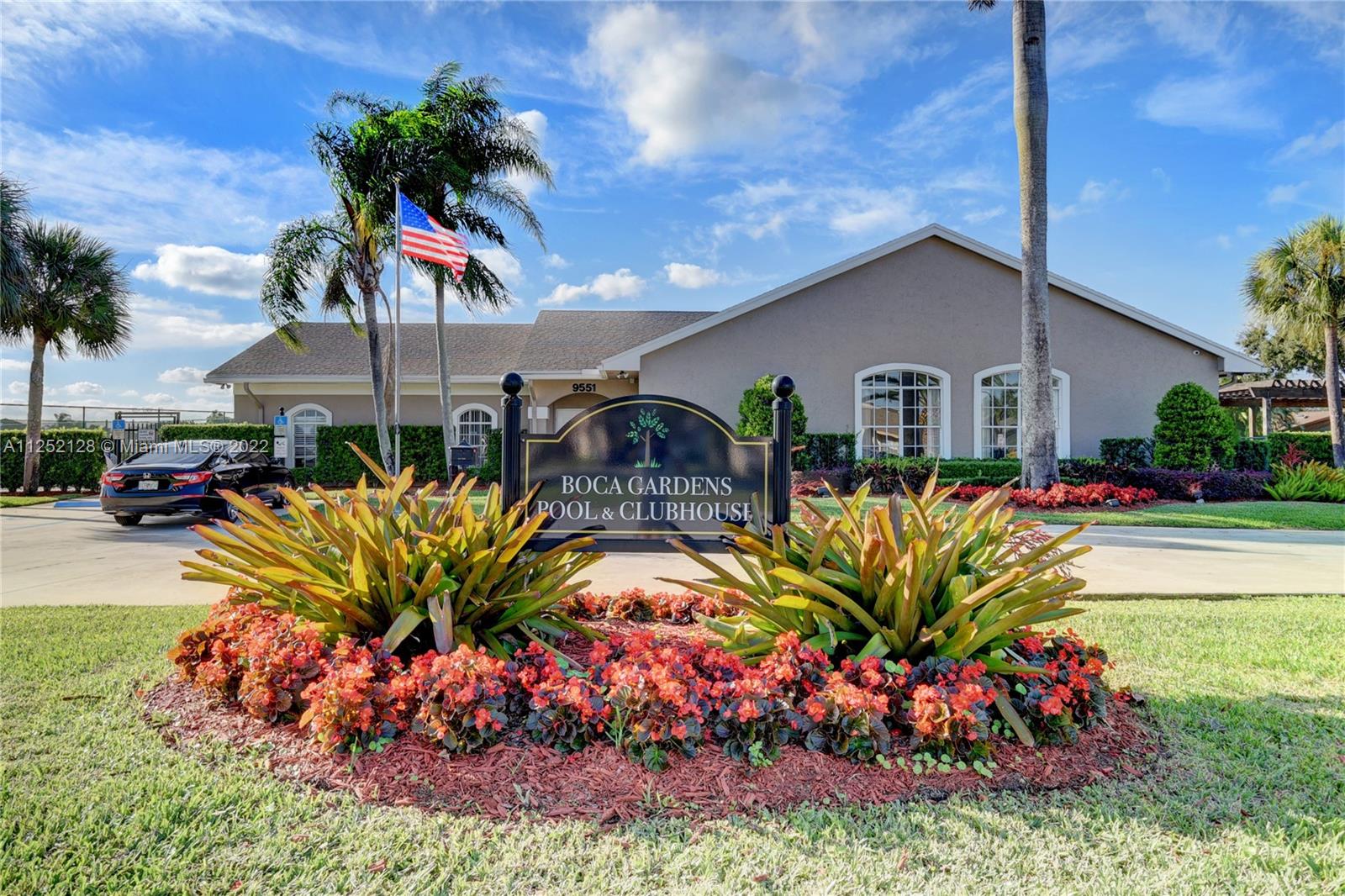 Boca Gardens Boca Raton, FL 33496 - Photo 15 of 19 a front view of multi story residential apartment building with yard and outdoor seating