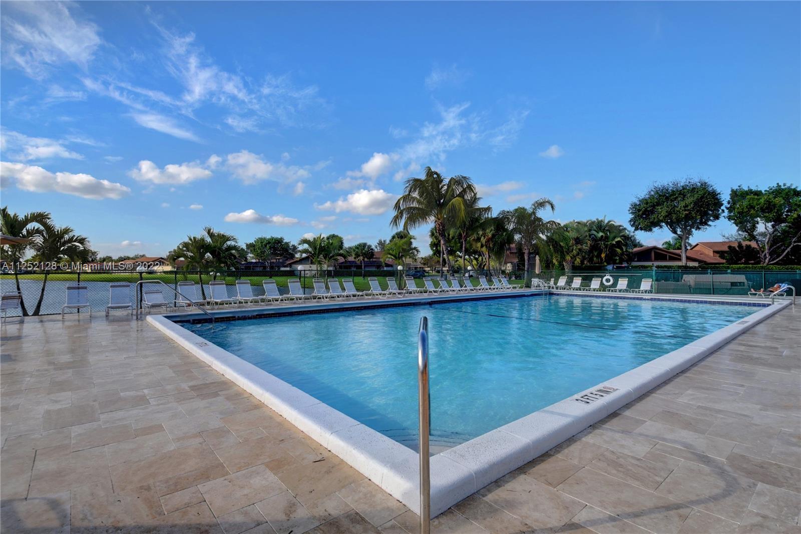 Boca Gardens Boca Raton, FL 33496 - Photo 16 of 19 a view of a swimming pool with a lake view