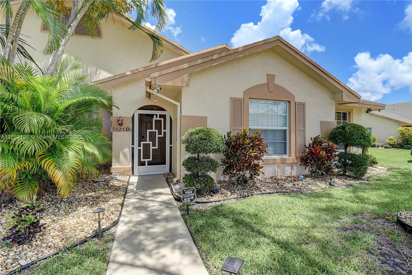 Boca Gardens Boca Raton, FL 33496 - Photo 2 of 19 a front view of a house with garden