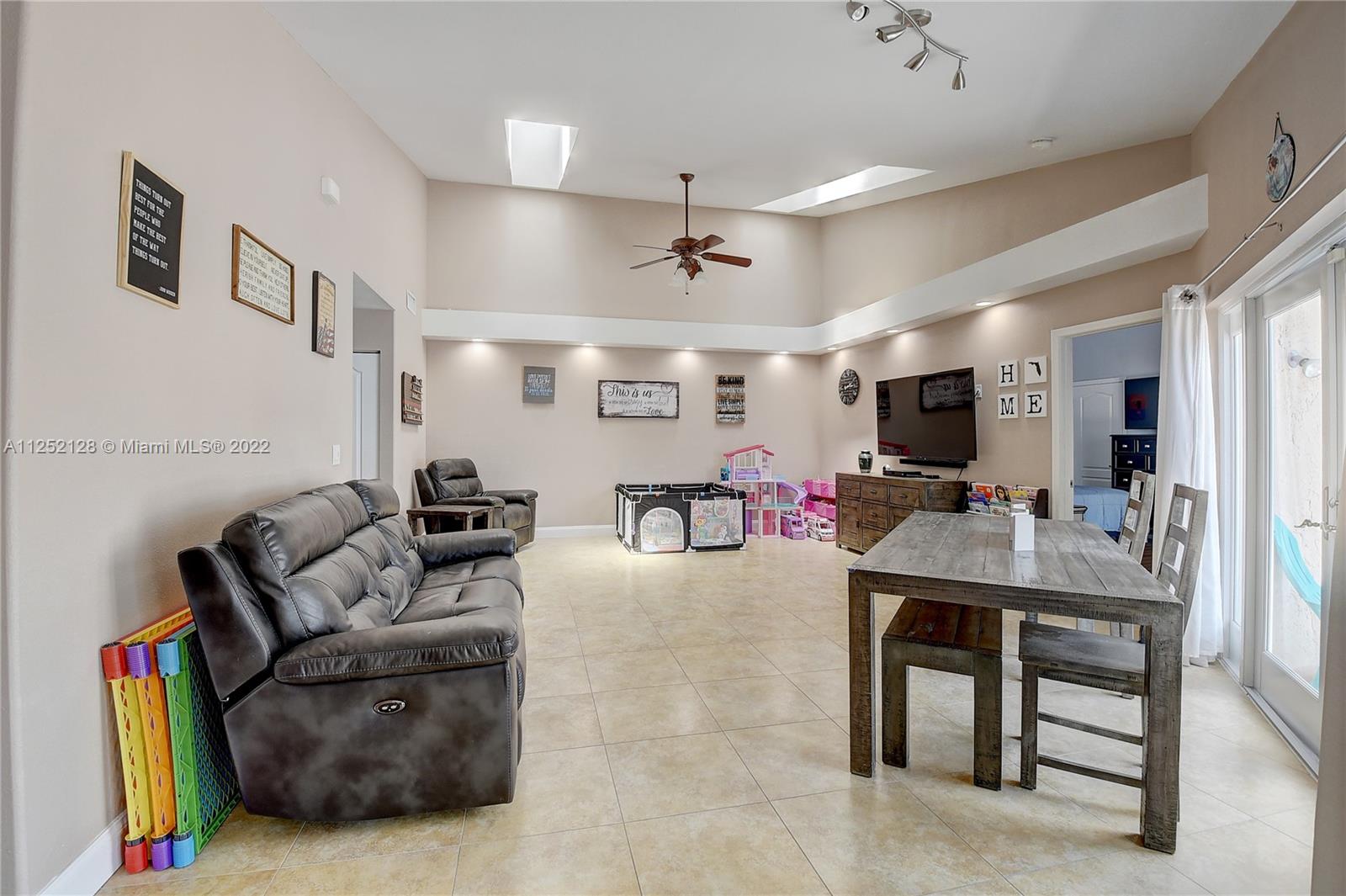 Boca Gardens Boca Raton, FL 33496 - Photo 3 of 19 a living room with furniture and a flat screen tv