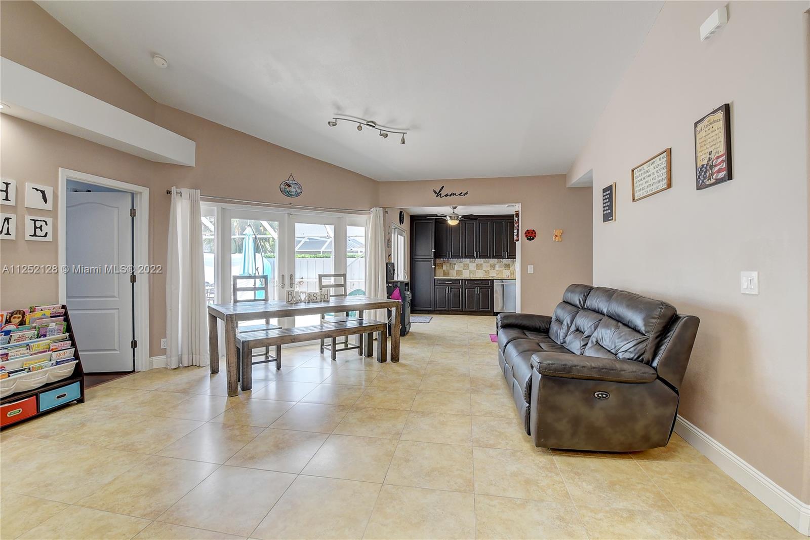 Boca Gardens Boca Raton, FL 33496 - Photo 4 of 19 a living room with furniture and a dining table with window