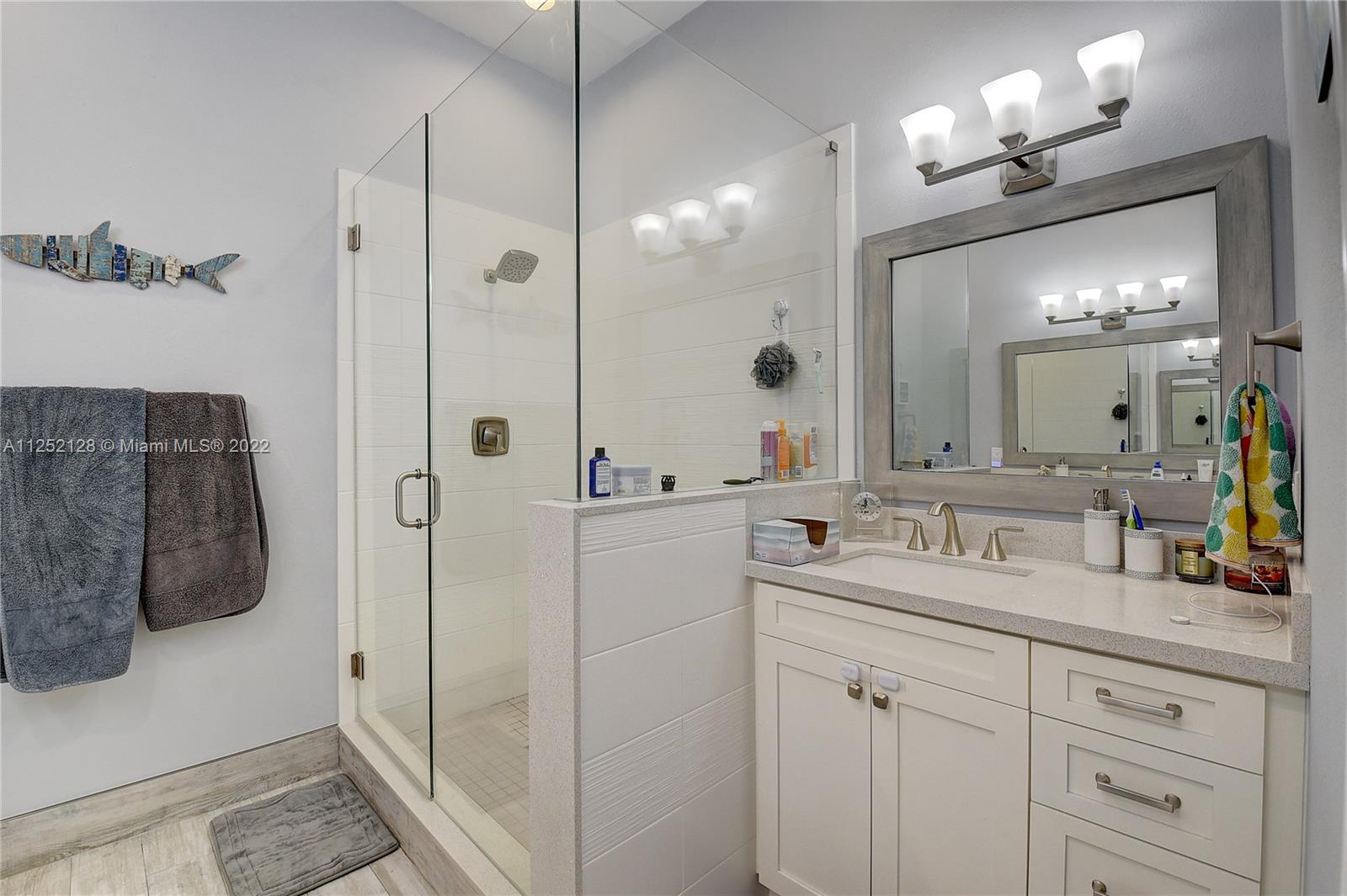 Boca Gardens Boca Raton, FL 33496 - Photo 8 of 19 a bathroom with a double vanity sink a mirror a vanity and a shower