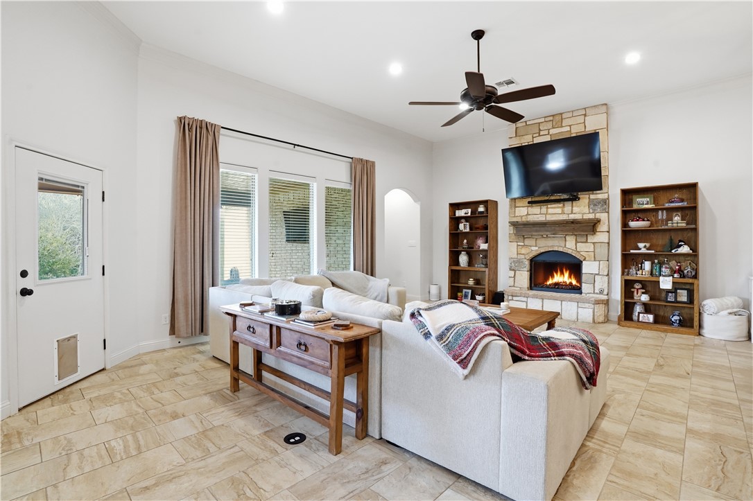 3516 Foxcroft Path Bryan, TX 77808 - Photo 12 of 38 a living room with furniture a fireplace and a flat screen tv