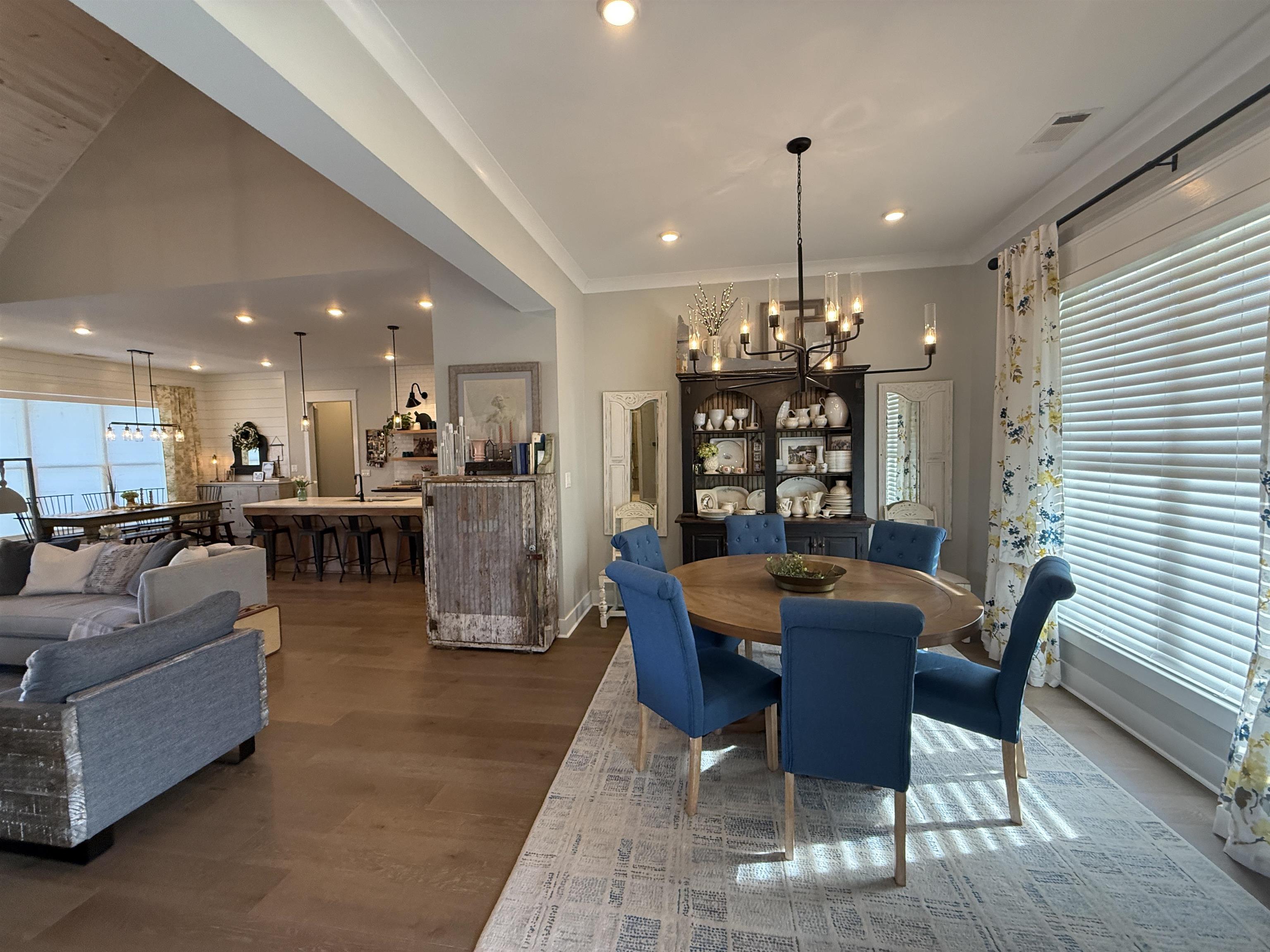 6900 Salem Road Lakeland, TN 38002 - Photo 19 of 40 Dining room featuring a chandelier, wood finished floors, and lofted ceiling