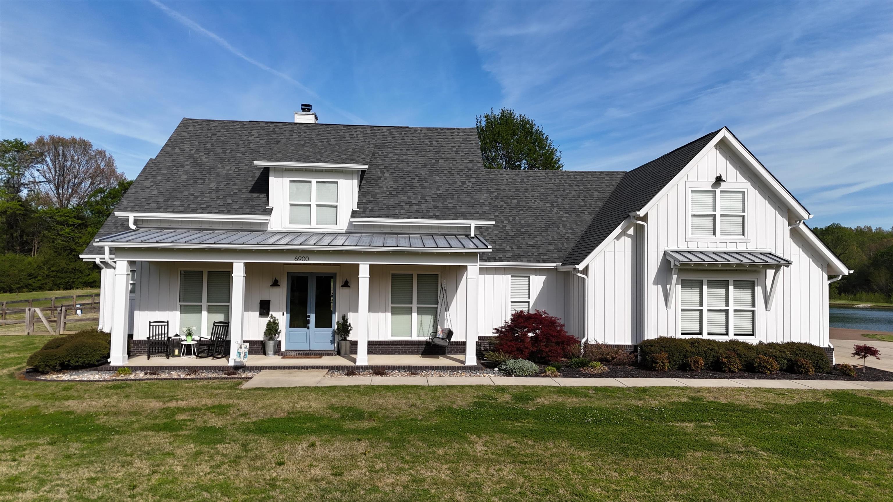 6900 Salem Road Lakeland, TN 38002 - Photo 3 of 40 Modern inspired farmhouse with board and batten siding, covered porch, a front yard, and a shingled roof