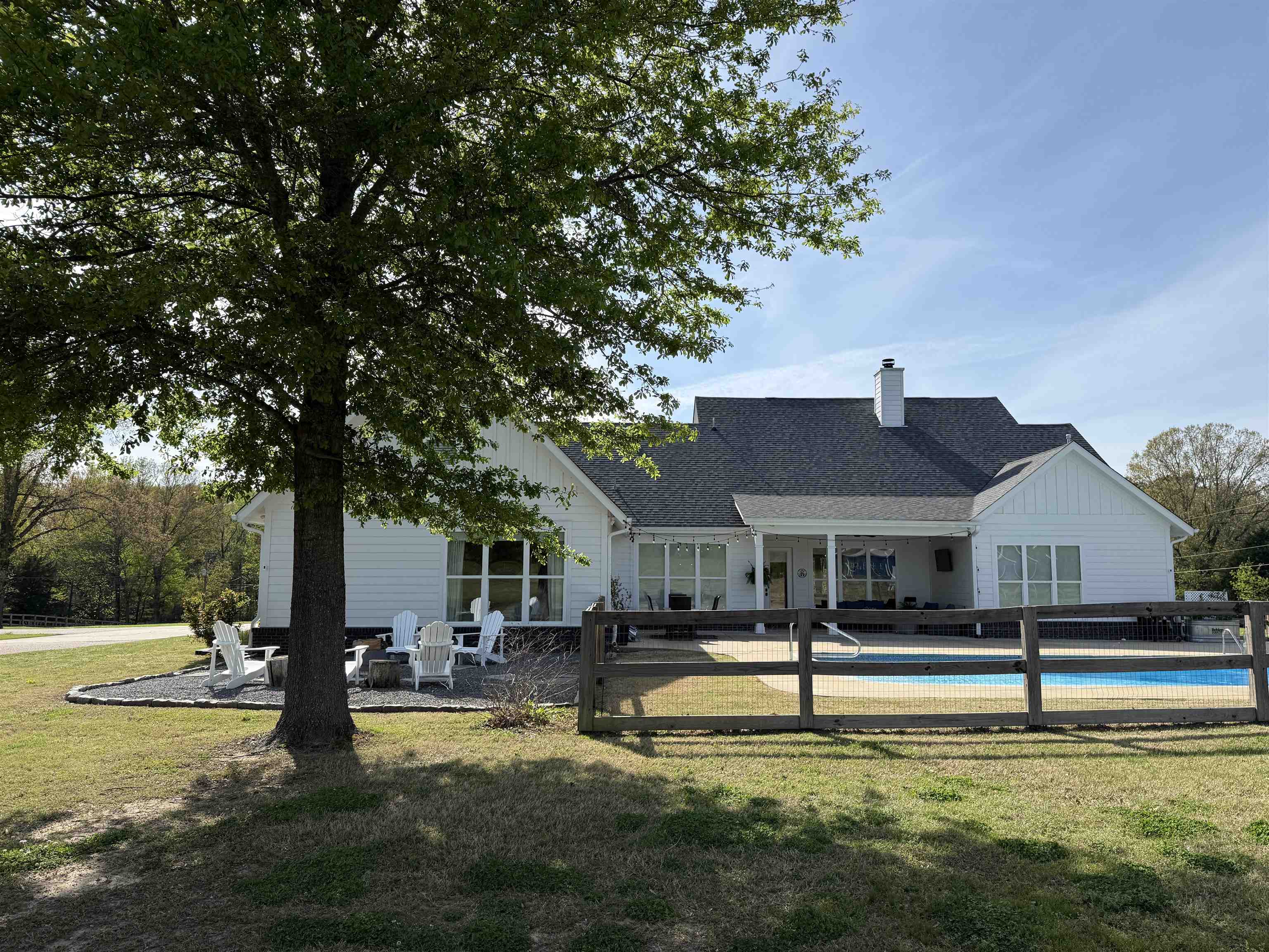 6900 Salem Road Lakeland, TN 38002 - Photo 9 of 40 Rear view of house with a patio, a shingled roof, board and batten siding, and a chimney