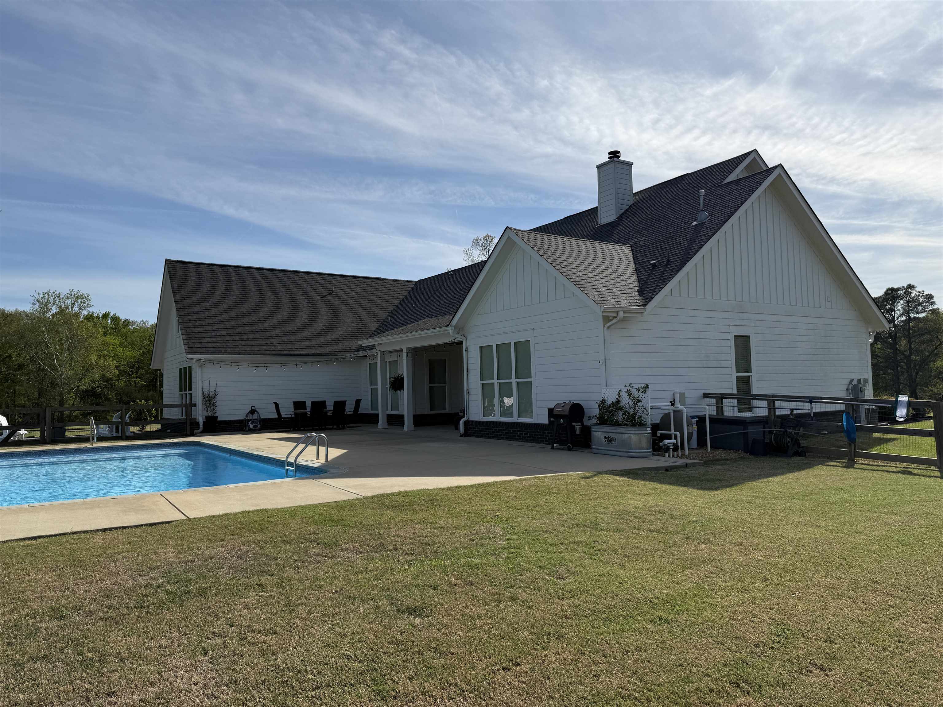 6900 Salem Road Lakeland, TN 38002 - Photo 10 of 40 Rear view of property with a patio area, a yard, roof with shingles, an outdoor pool, and board and batten siding