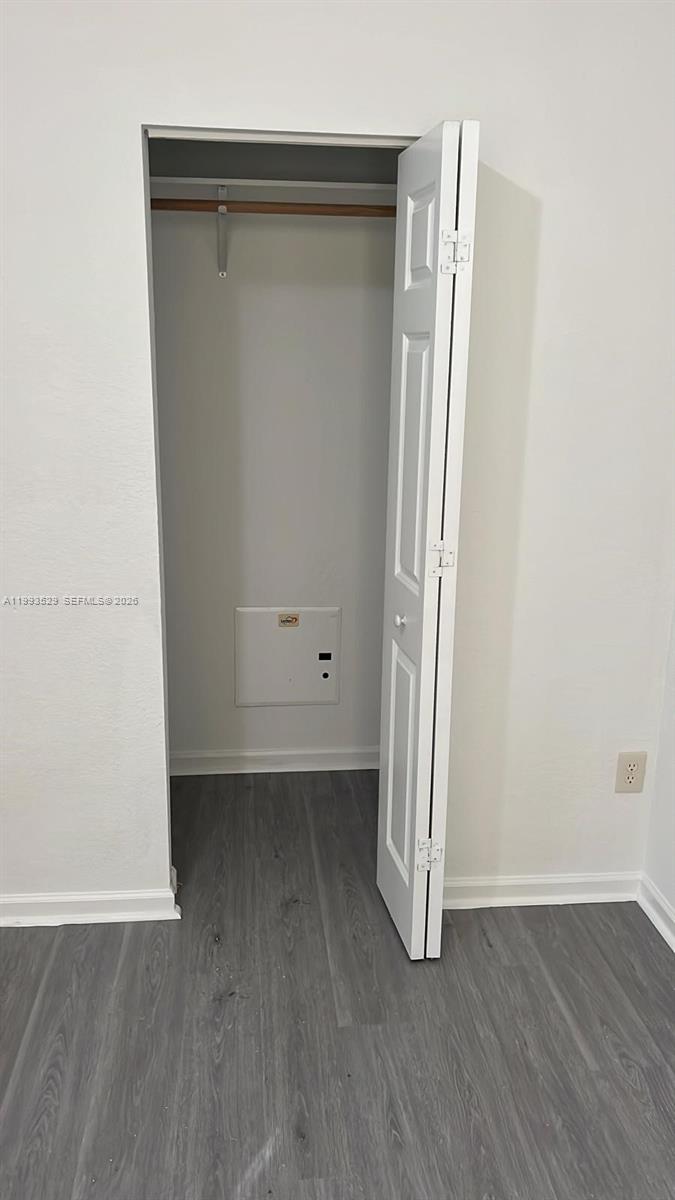 1953 Freeport Drive, Unit 1953 Riviera Beach, FL 33404 - Photo 17 of 30 an empty room with wooden floor and closet