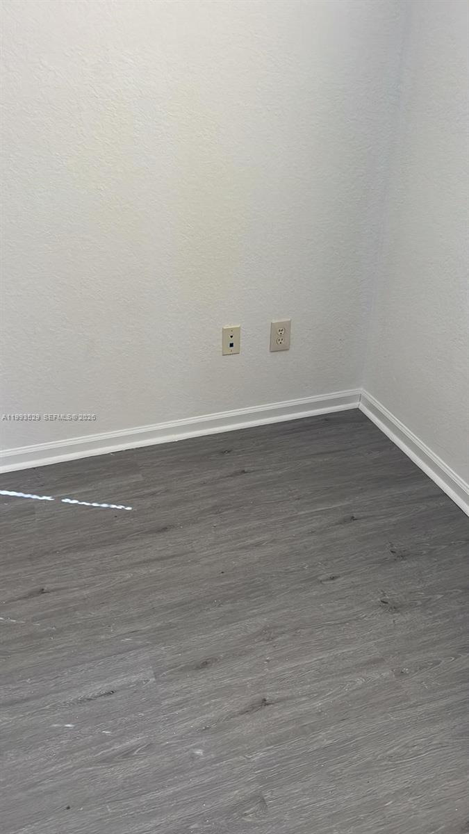1953 Freeport Drive, Unit 1953 Riviera Beach, FL 33404 - Photo 22 of 30 a view of an empty room with wooden floor