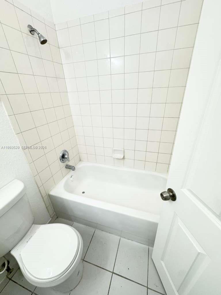 1953 Freeport Drive, Unit 1953 Riviera Beach, FL 33404 - Photo 23 of 30 a bathroom with a toilet bathtub and shower