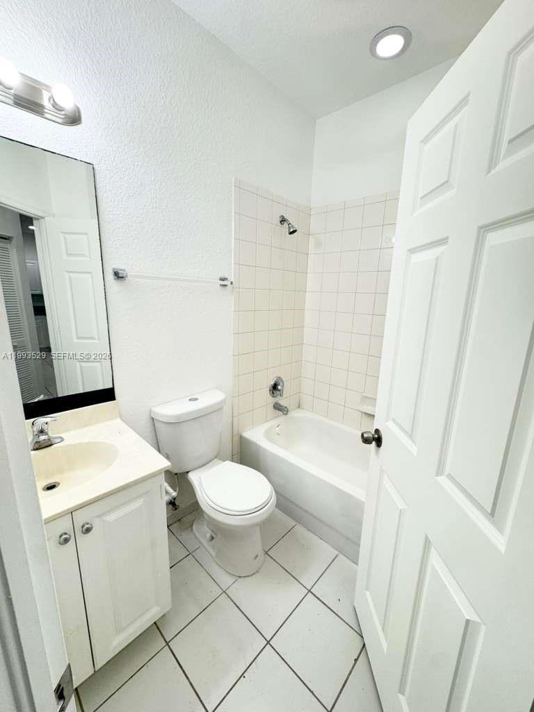 1953 Freeport Drive, Unit 1953 Riviera Beach, FL 33404 - Photo 24 of 30 a bathroom with a sink a toilet and shower