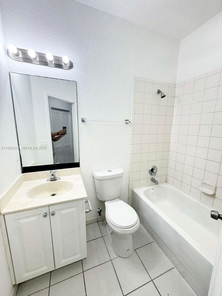 1953 Freeport Drive, Unit 1953 Riviera Beach, FL 33404 - Photo 25 of 30 a bathroom with a toilet sink and mirror
