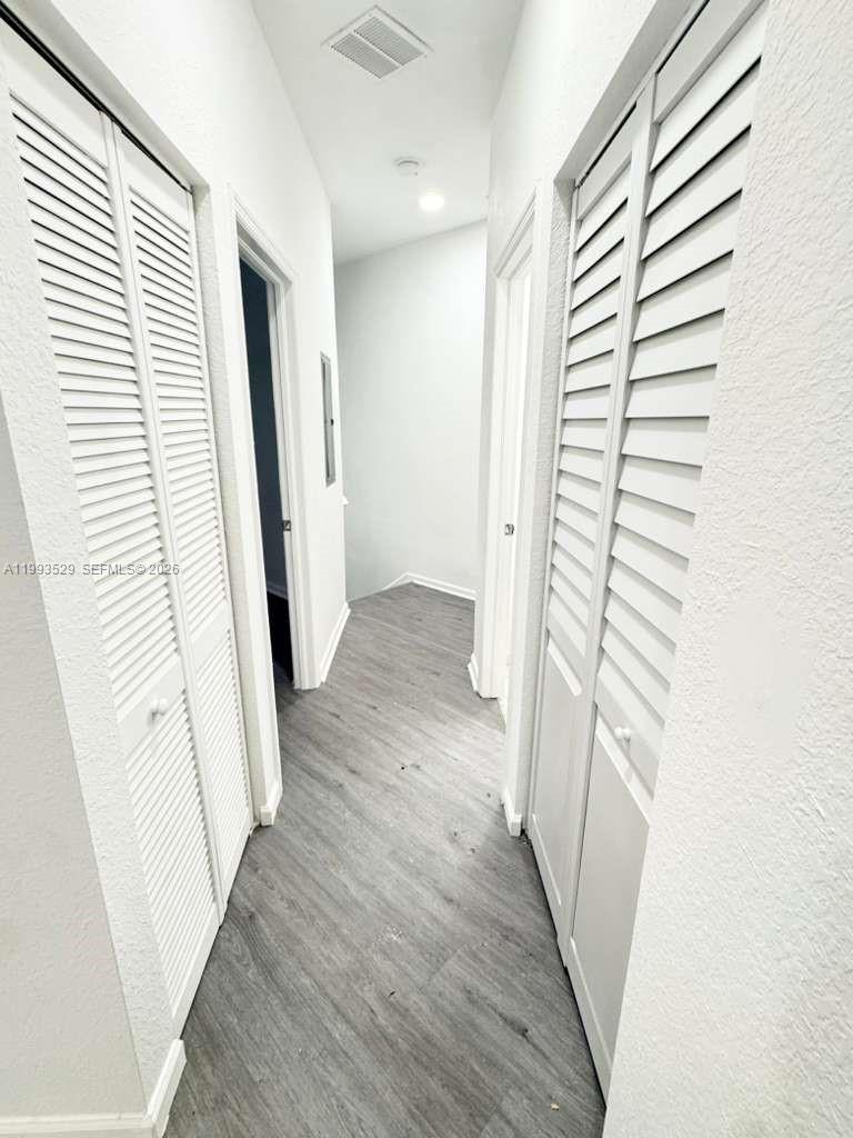 1953 Freeport Drive, Unit 1953 Riviera Beach, FL 33404 - Photo 29 of 30 a view of a hallway with wooden floor and staircase