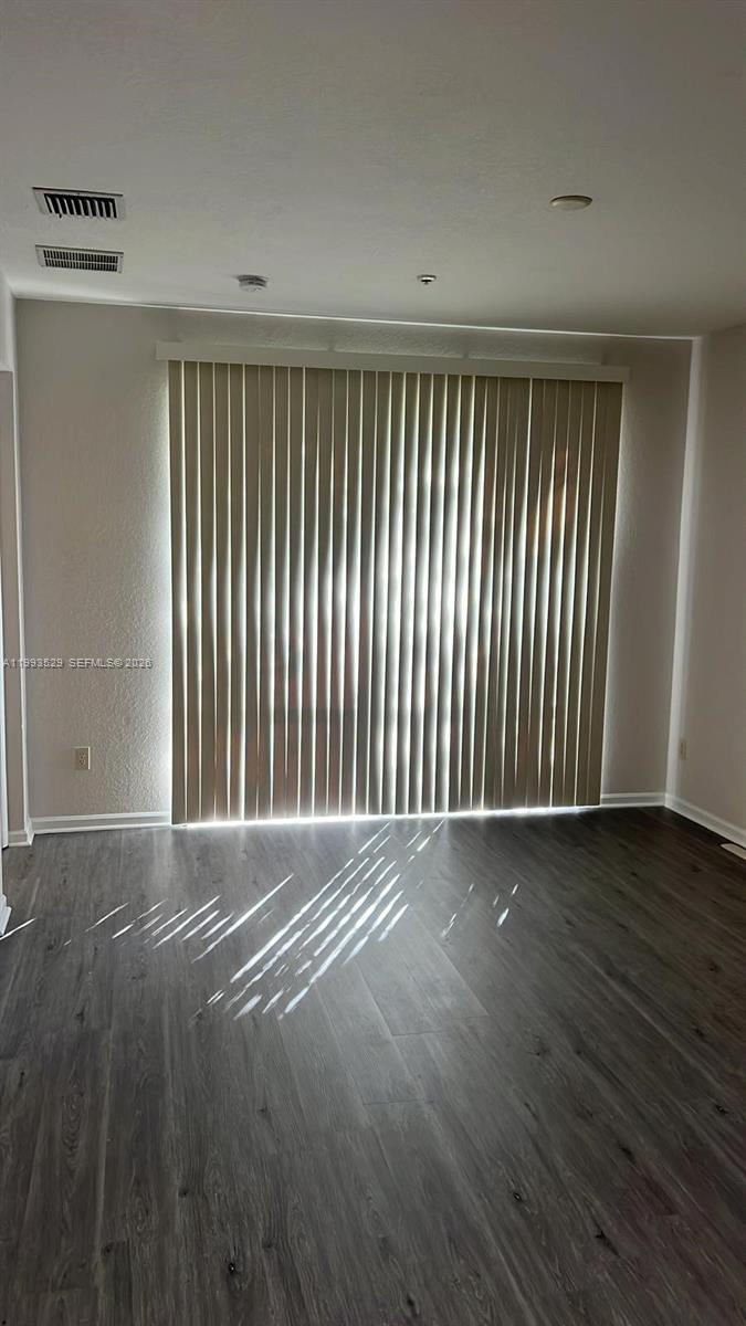 1953 Freeport Drive, Unit 1953 Riviera Beach, FL 33404 - Photo 5 of 30 an empty room with wooden floor and windows