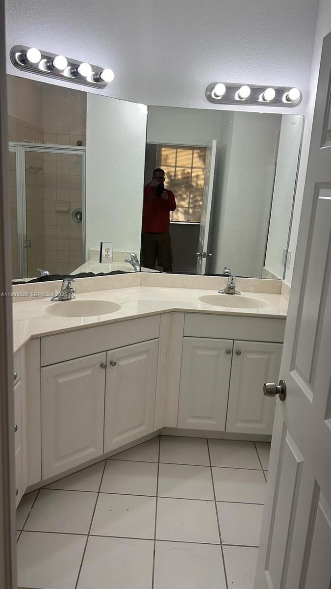 1953 Freeport Drive, Unit 1953 Riviera Beach, FL 33404 - Photo 6 of 30 a bathroom with a sink vanity and mirror