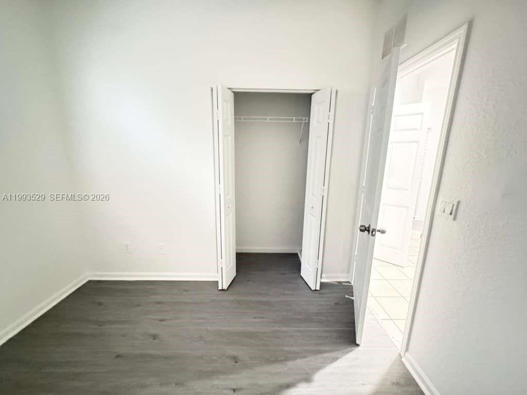 1953 Freeport Drive, Unit 1953 Riviera Beach, FL 33404 - Photo 7 of 30 a view of an empty room with wooden floor