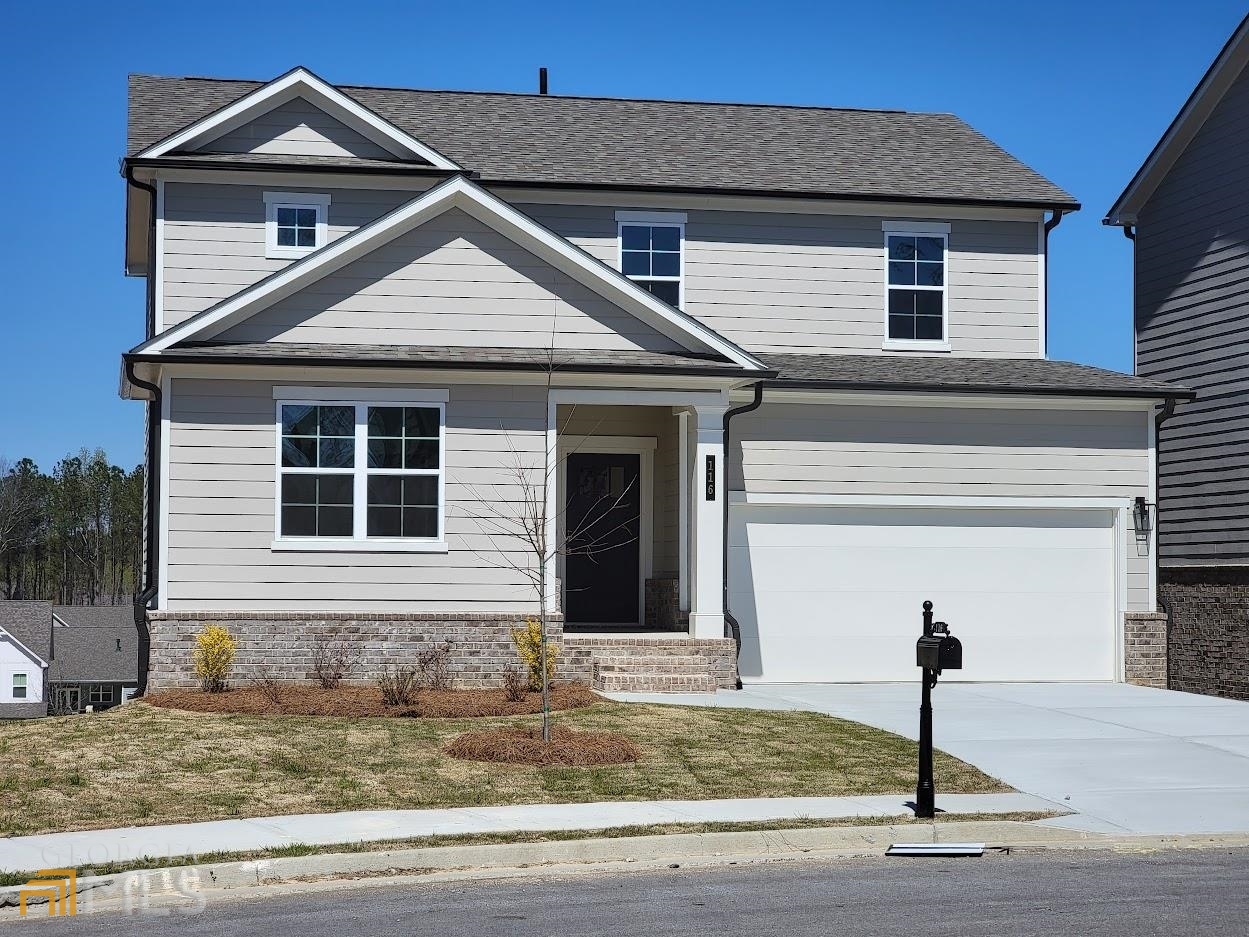 a front view of a house with a yard