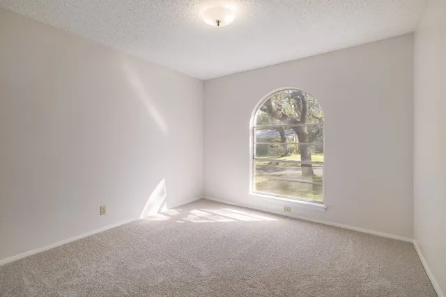 an empty room with large windows