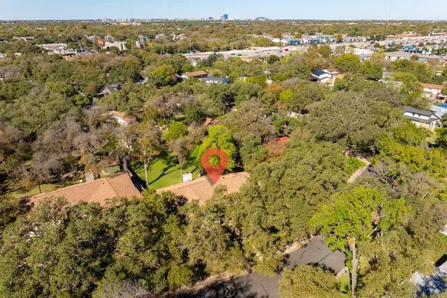 an aerial view of a house with lots of trees