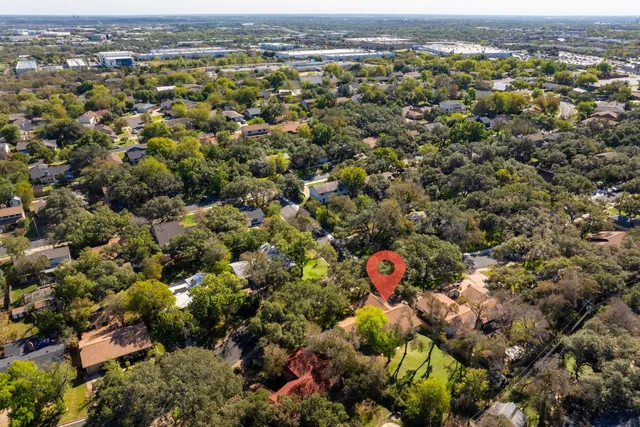 an aerial view of residential houses with city view