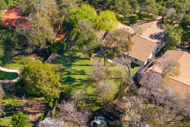 an aerial view of a house with a yard