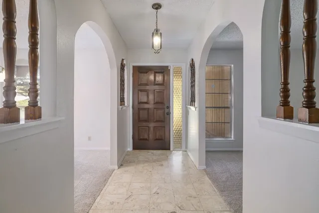 an empty room with windows and cabinet