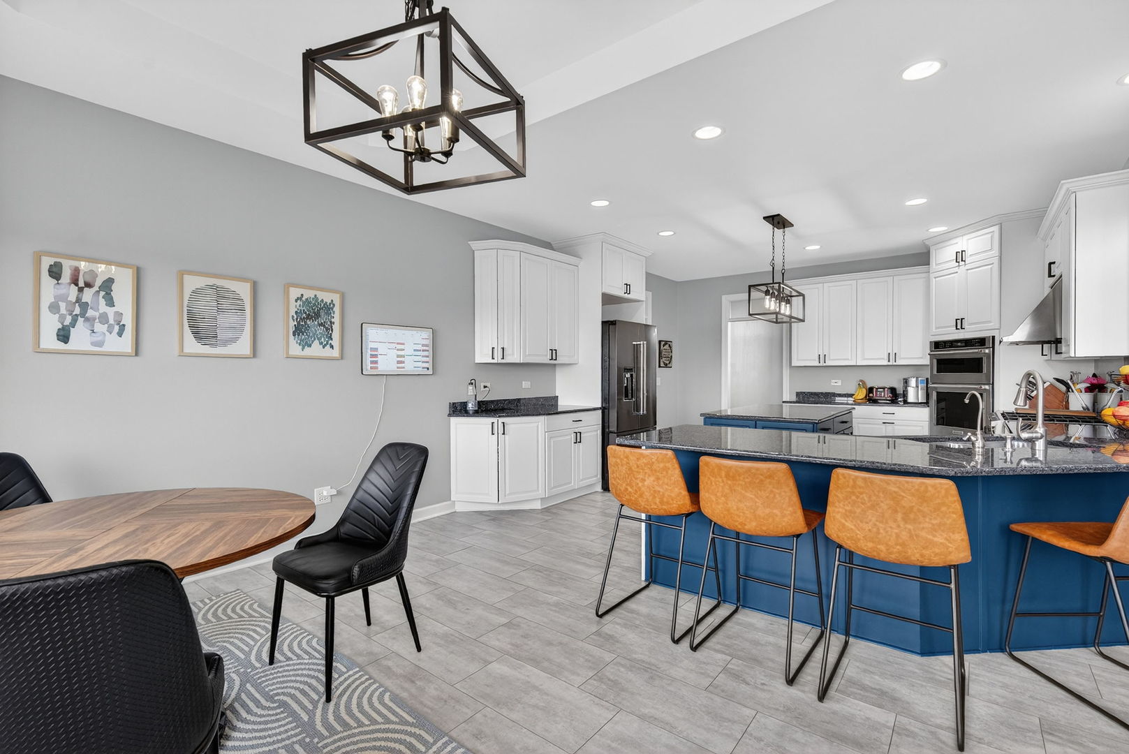 2804 Ninovan Lane Minooka, IL 60447 - Photo 19 of 67 a kitchen with stainless steel appliances granite countertop a dining table chairs and a refrigerator