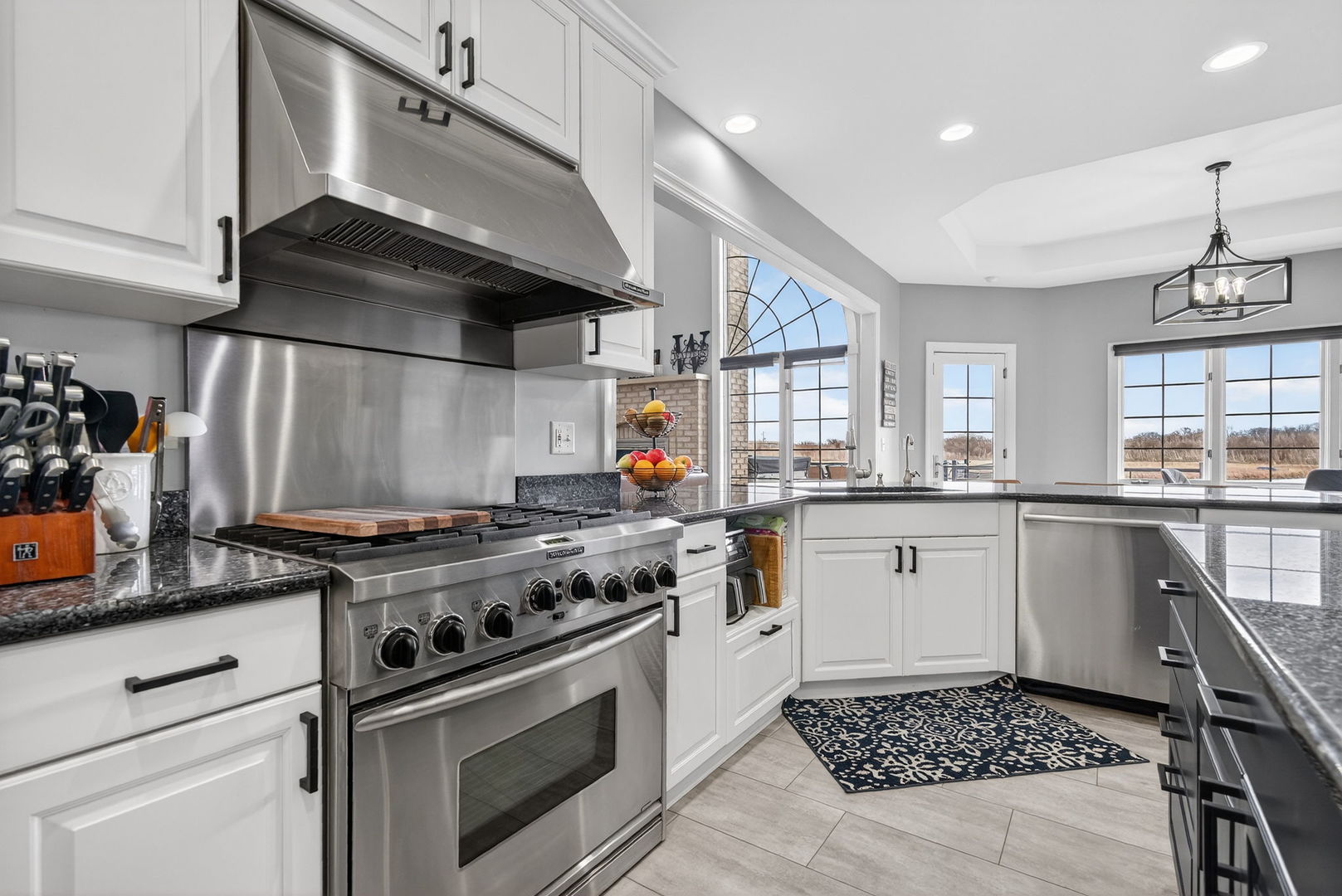 2804 Ninovan Lane Minooka, IL 60447 - Photo 25 of 67 a kitchen with a stove and white cabinets