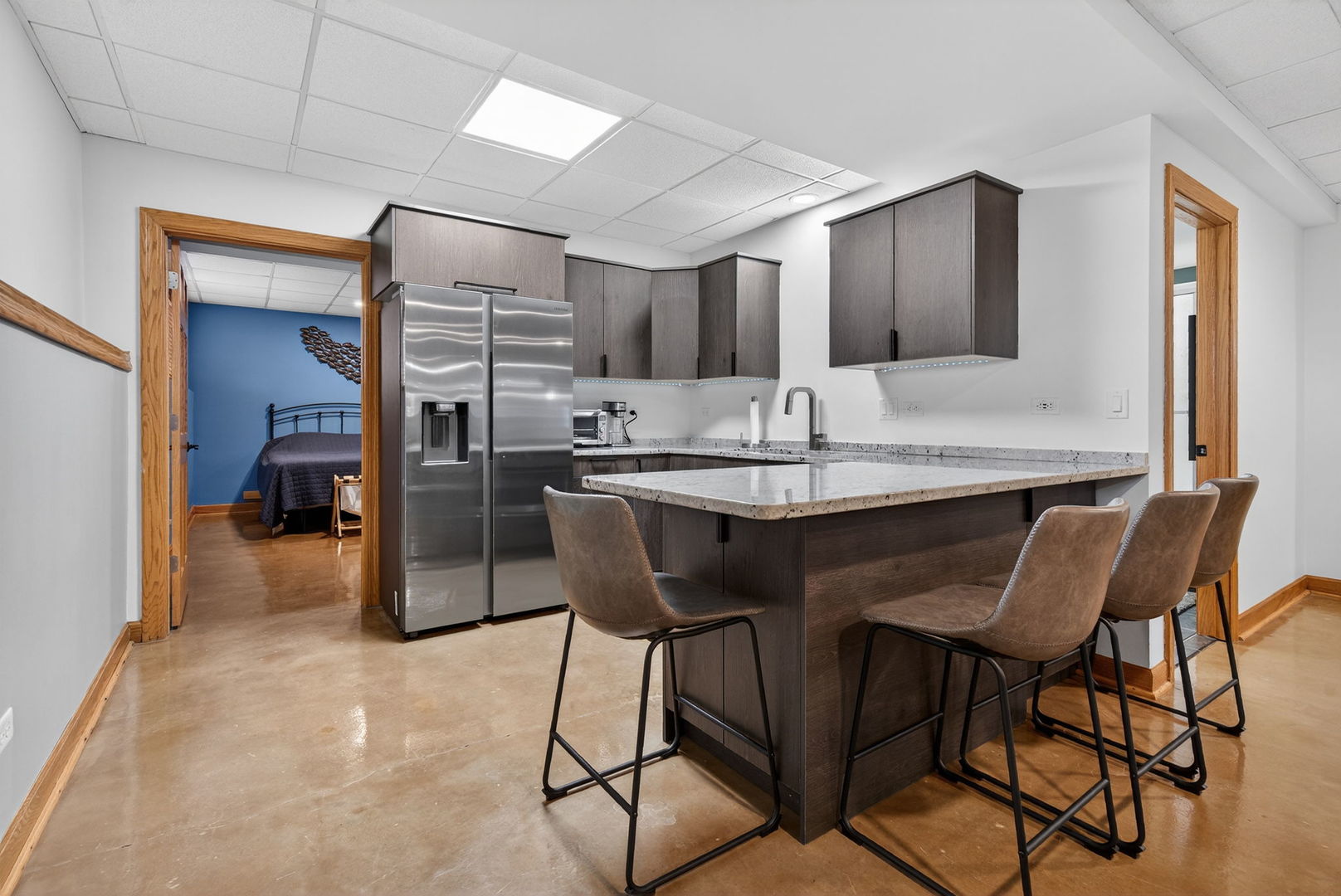 2804 Ninovan Lane Minooka, IL 60447 - Photo 52 of 67 a kitchen with stainless steel appliances kitchen island granite countertop a table chairs sink and cabinets