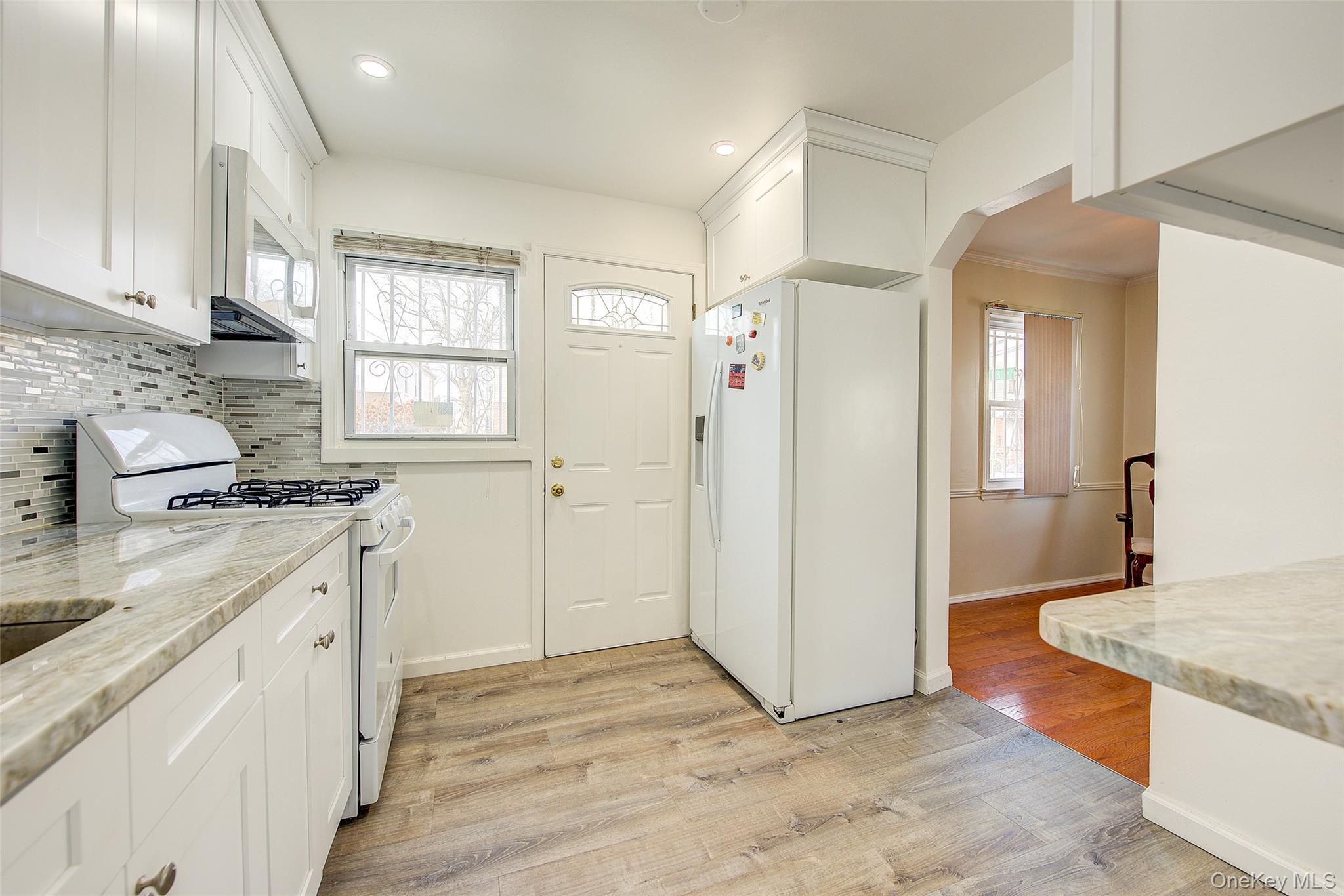 220-04 103rd Avenue Queens, NY 11429 - Photo 11 of 35 a kitchen with granite countertop a sink stove and refrigerator