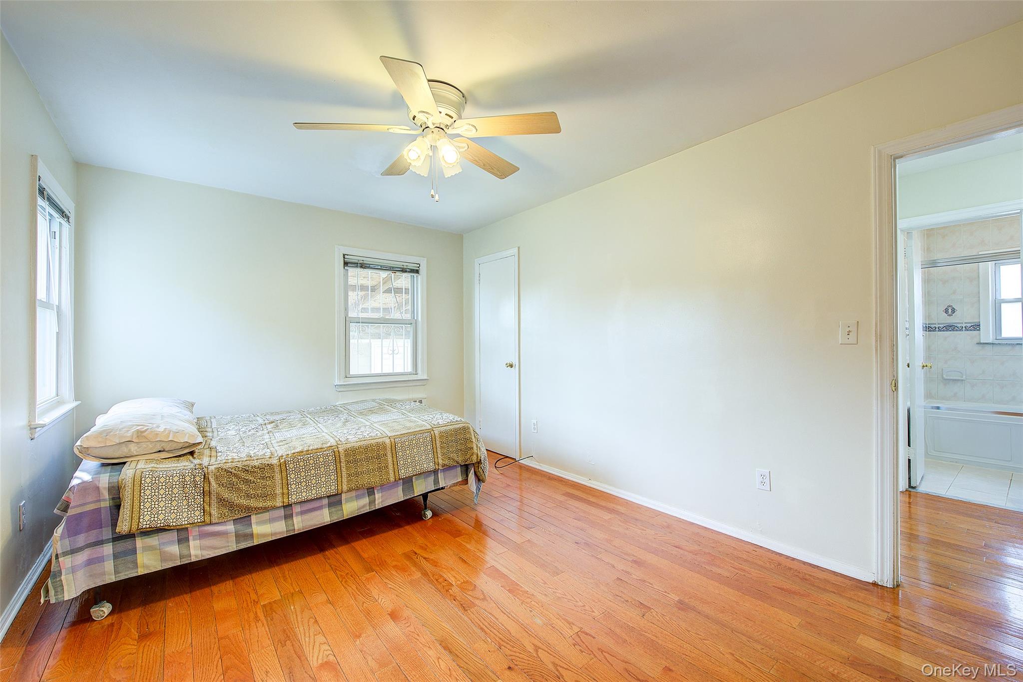 220-04 103rd Avenue Queens, NY 11429 - Photo 15 of 35 a bedroom with a bed and wooden floor