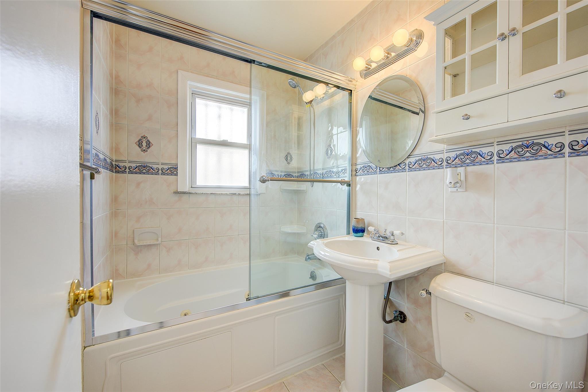 220-04 103rd Avenue Queens, NY 11429 - Photo 16 of 35 a bathroom with a sink mirror toilet and shower