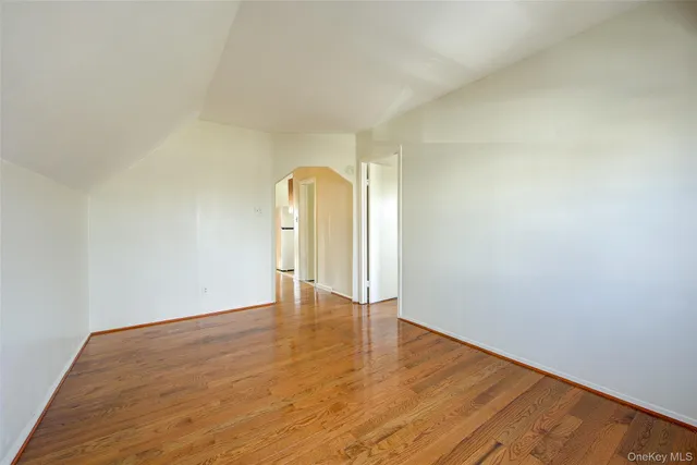 a view of an empty room and wooden floor