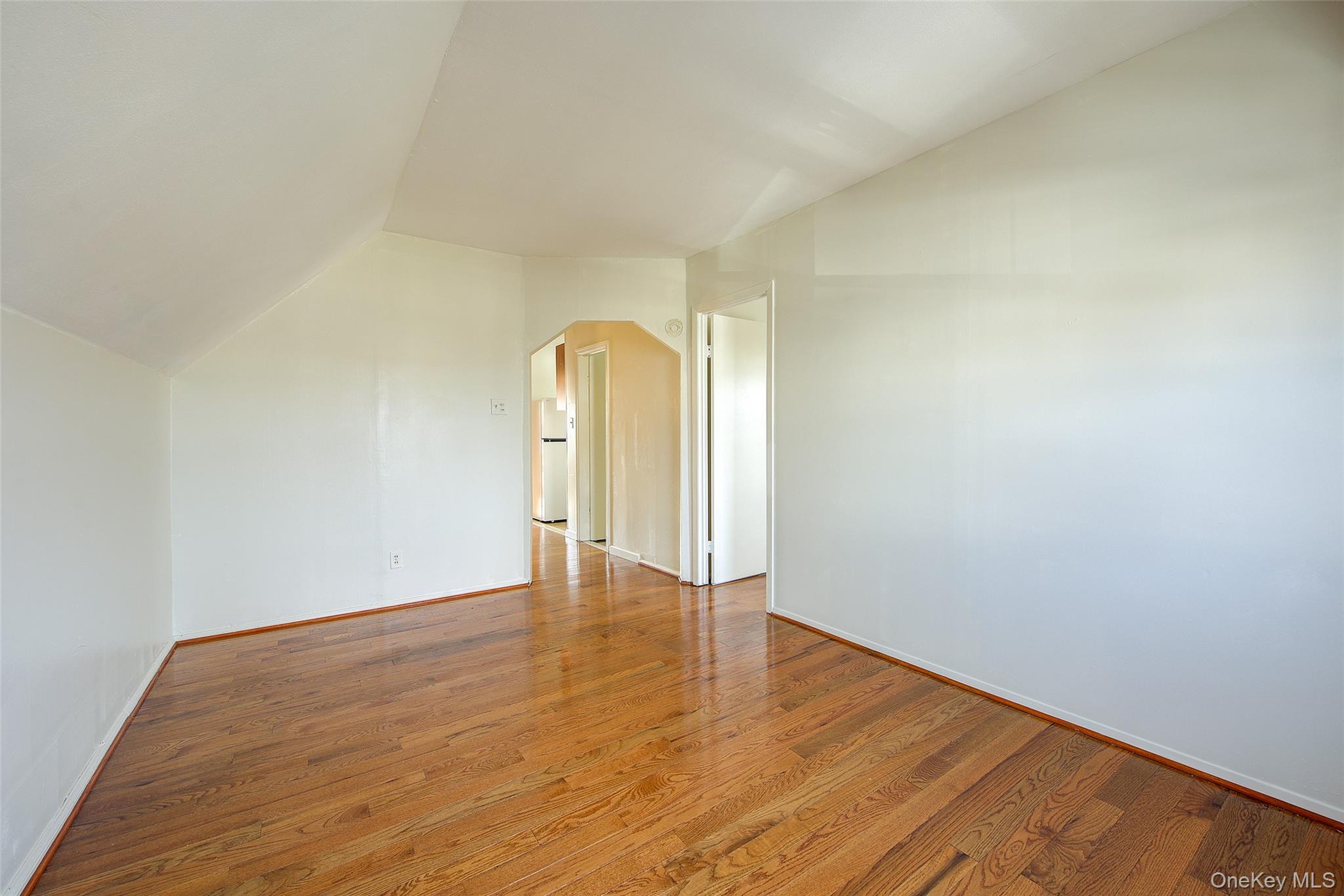 220-04 103rd Avenue Queens, NY 11429 - Photo 19 of 35 a view of an empty room and wooden floor