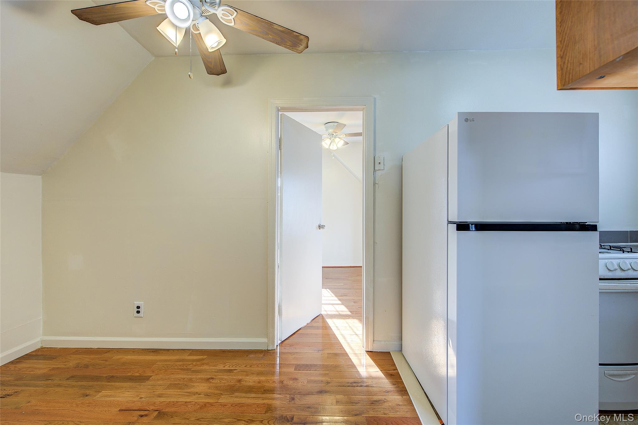 220-04 103rd Avenue Queens, NY 11429 - Photo 22 of 35 a view of an empty room with wooden floor and a window