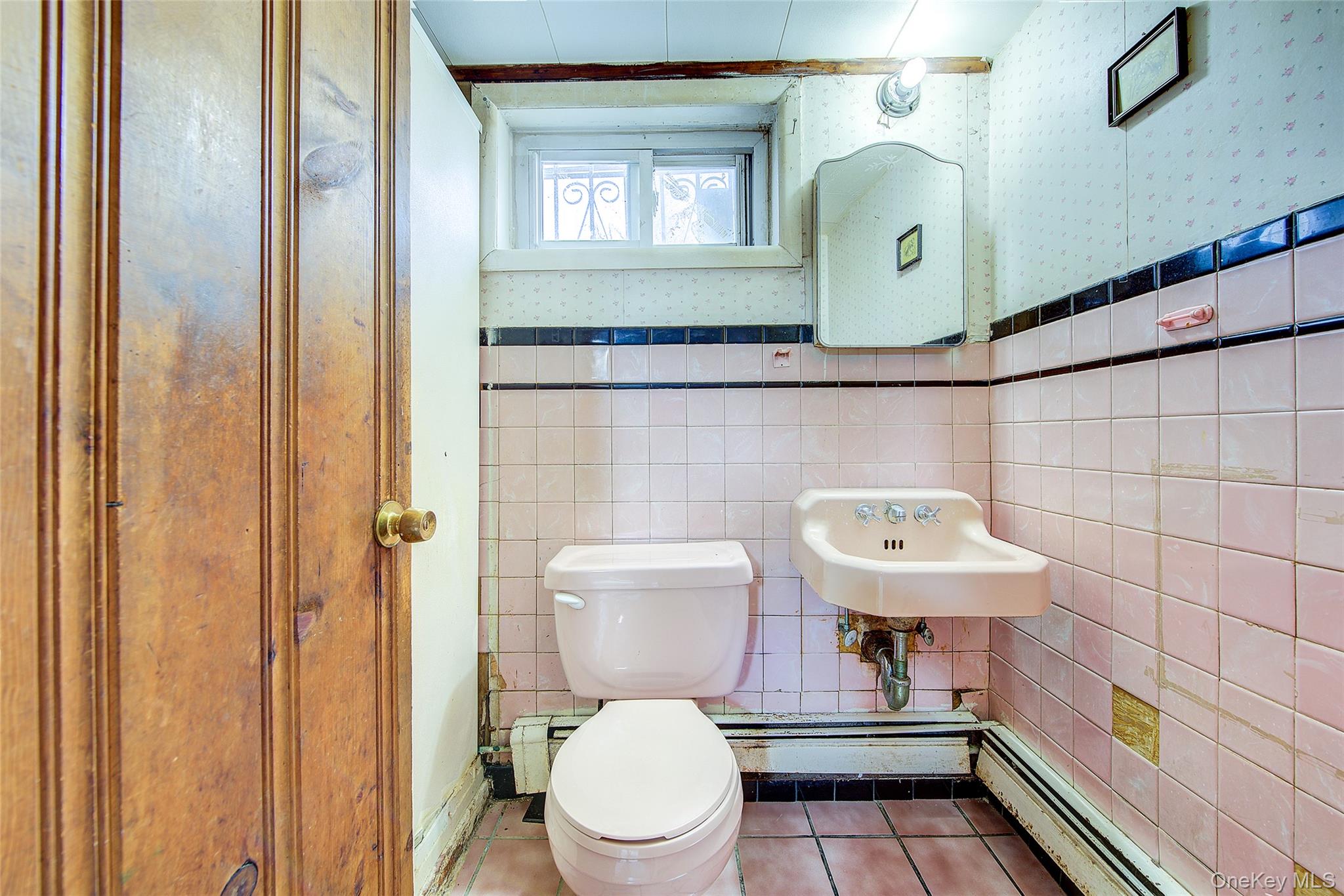 220-04 103rd Avenue Queens, NY 11429 - Photo 29 of 35 a bathroom with a toilet a sink and mirror