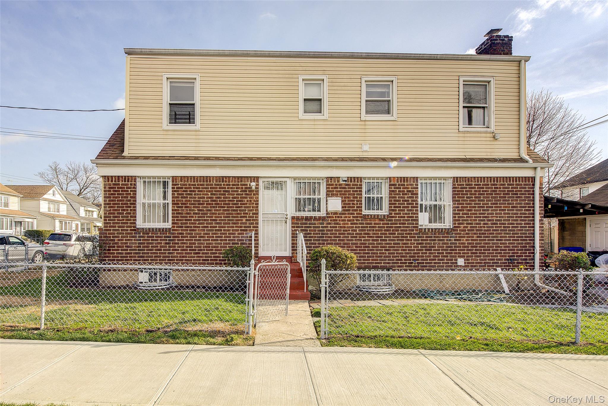 220-04 103rd Avenue Queens, NY 11429 - Photo 3 of 35 a front view of a house with a yard