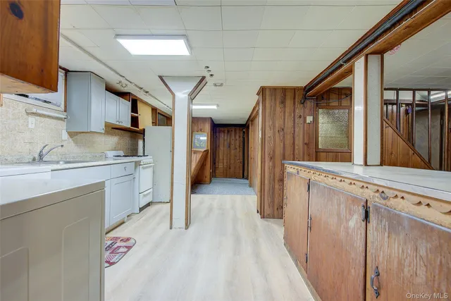 a kitchen with granite countertop a sink stove and cabinets