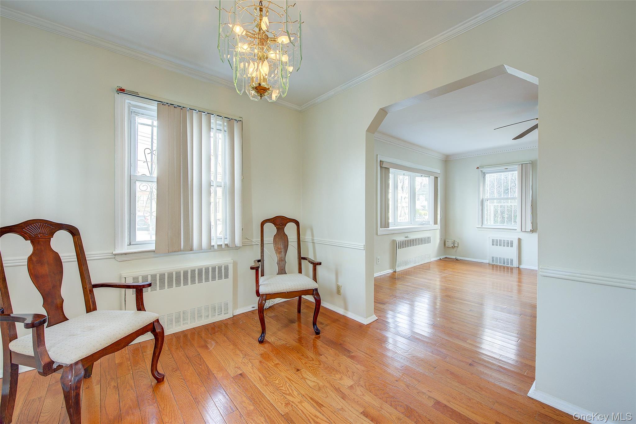 220-04 103rd Avenue Queens, NY 11429 - Photo 9 of 35 a view of a livingroom with furniture a chandelier windows and wooden floor