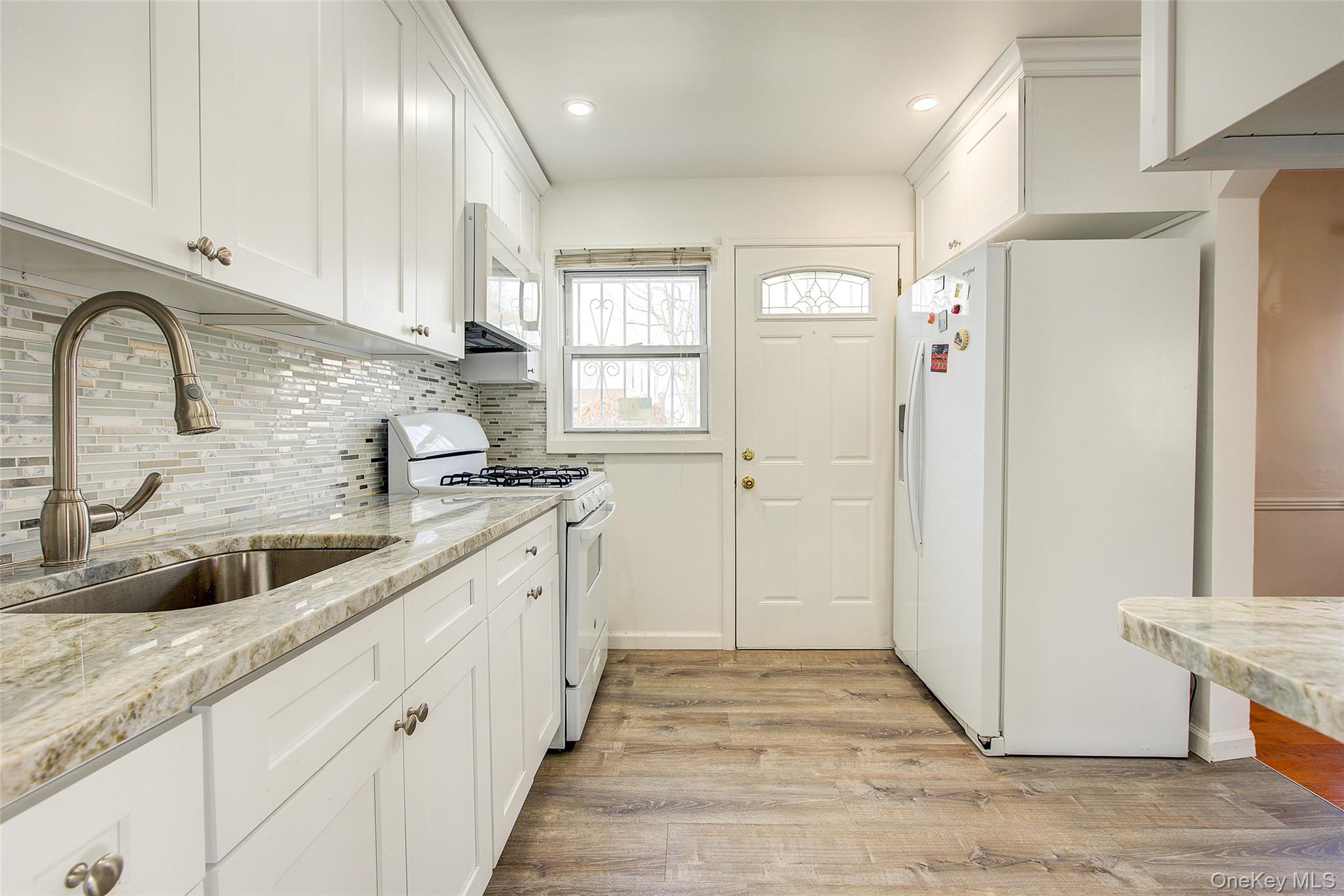 220-04 103rd Avenue Queens, NY 11429 - Photo 10 of 35 a kitchen with stainless steel appliances granite countertop a refrigerator and a sink