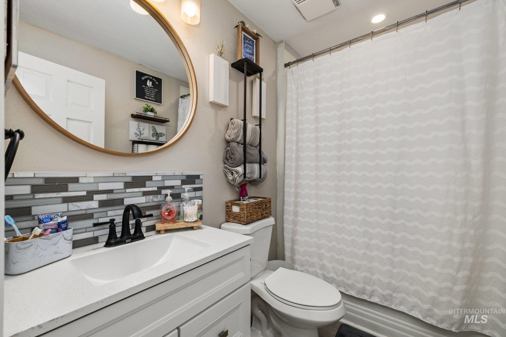 1504 2nd Street North Nampa, ID 83687 - Photo 21 of 29 Full bath featuring vanity and tasteful backsplash