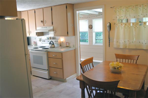 19 Edith Road Weymouth, MA 02189 - Photo 3 of 19 a kitchen with stainless steel appliances granite countertop a dining table chairs cabinets a sink and a refrigerator