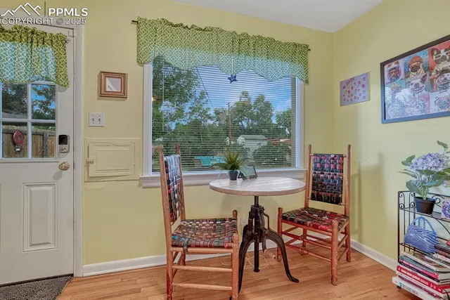 a dining room with furniture and wooden floor