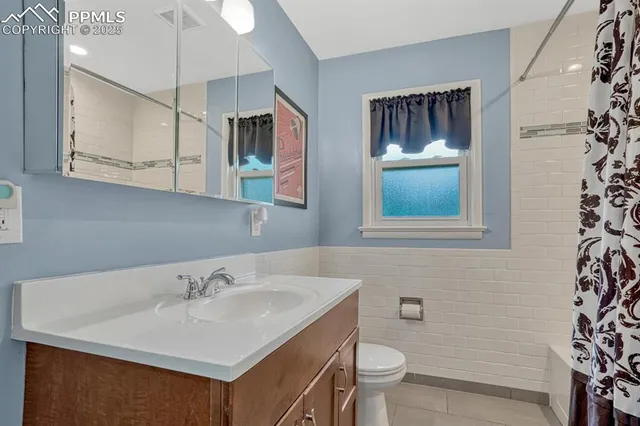 a bathroom with a sink toilet and mirror