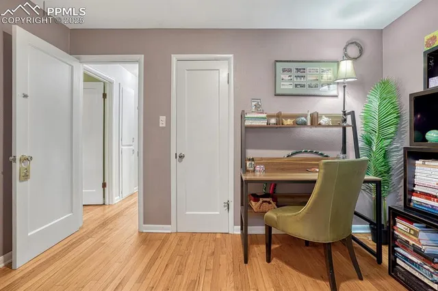 a view of a workspace with furniture and wooden floor