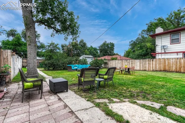 a view of backyard with sitting area
