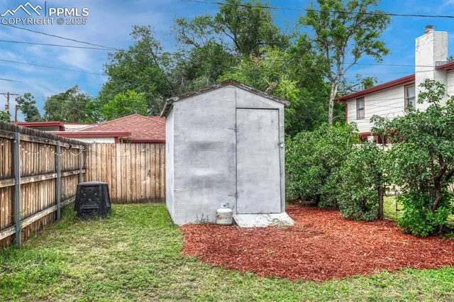 a backyard of a house with a small garden