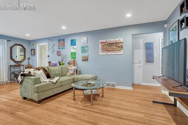 a living room with furniture and wooden floor